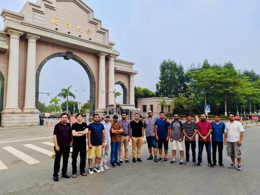 With friends in front of the Xiamen University Xiang’an campus gate